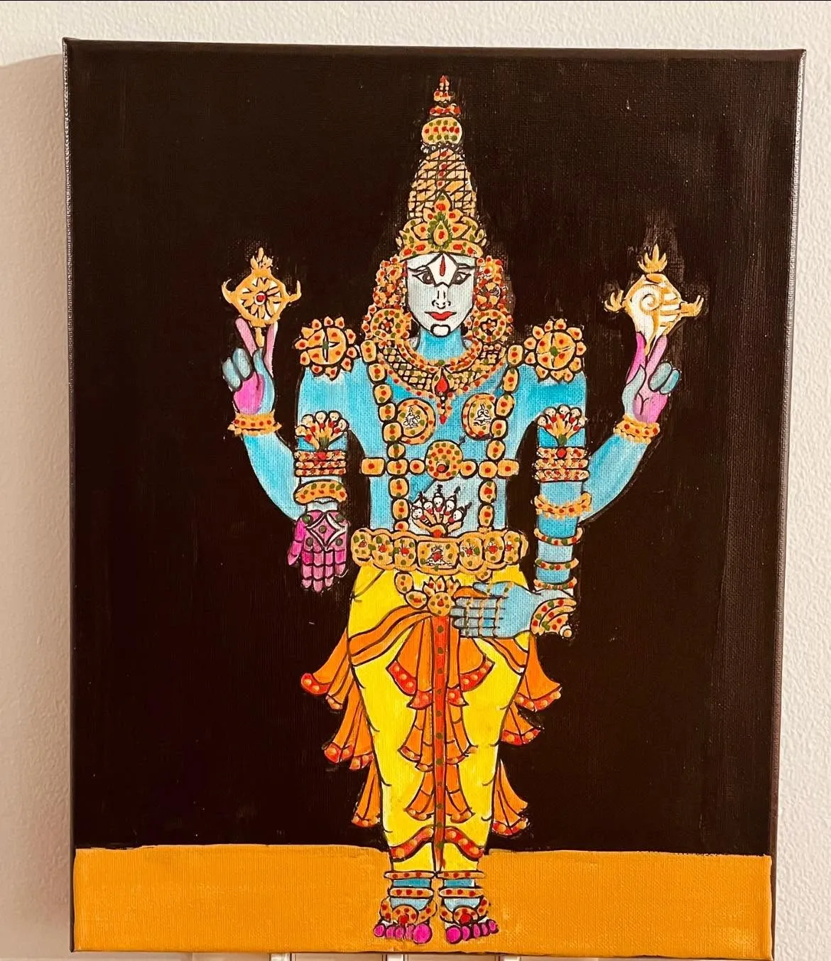 A painting of Lord Venkateswara in jeweled ornaments on a black background