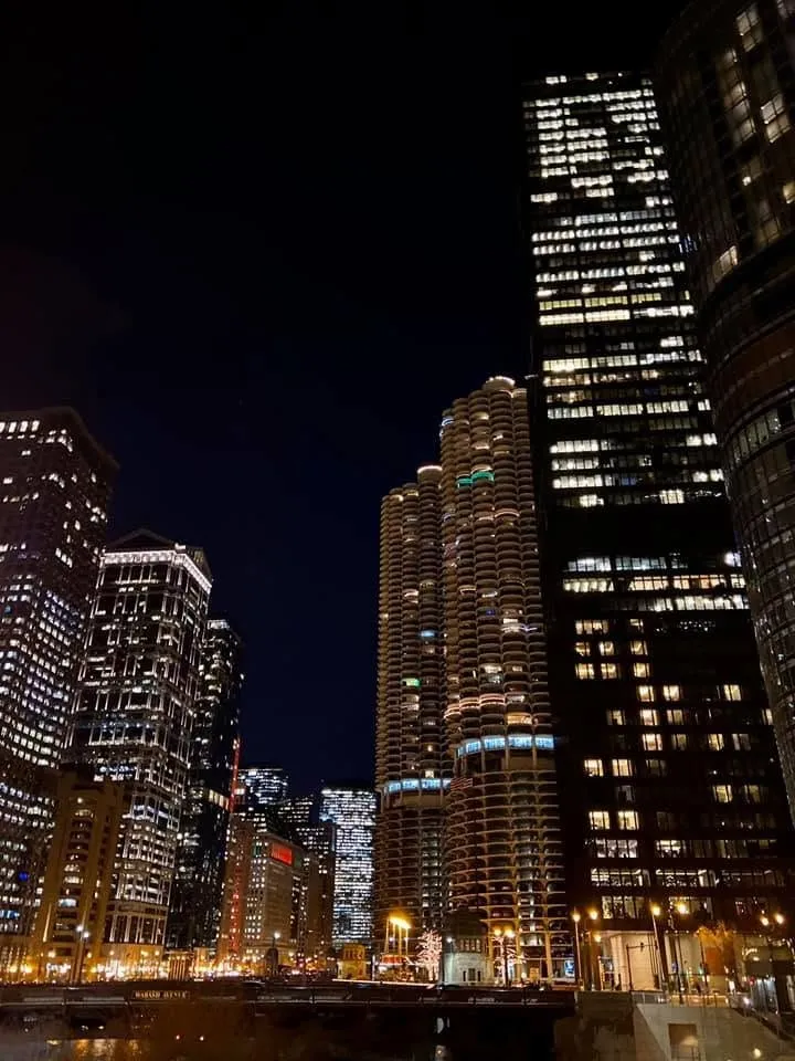 Looking up at Marina City’s round towers and lit office buildings against the night sky