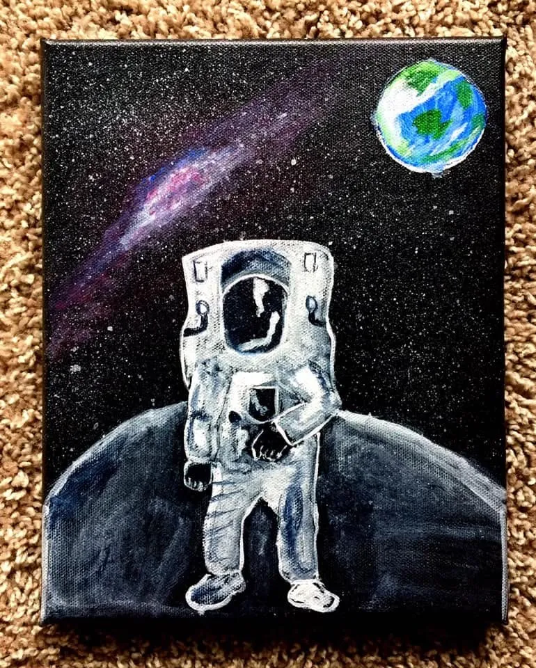 An astronaut standing on the moon with Earth and the Milky Way behind